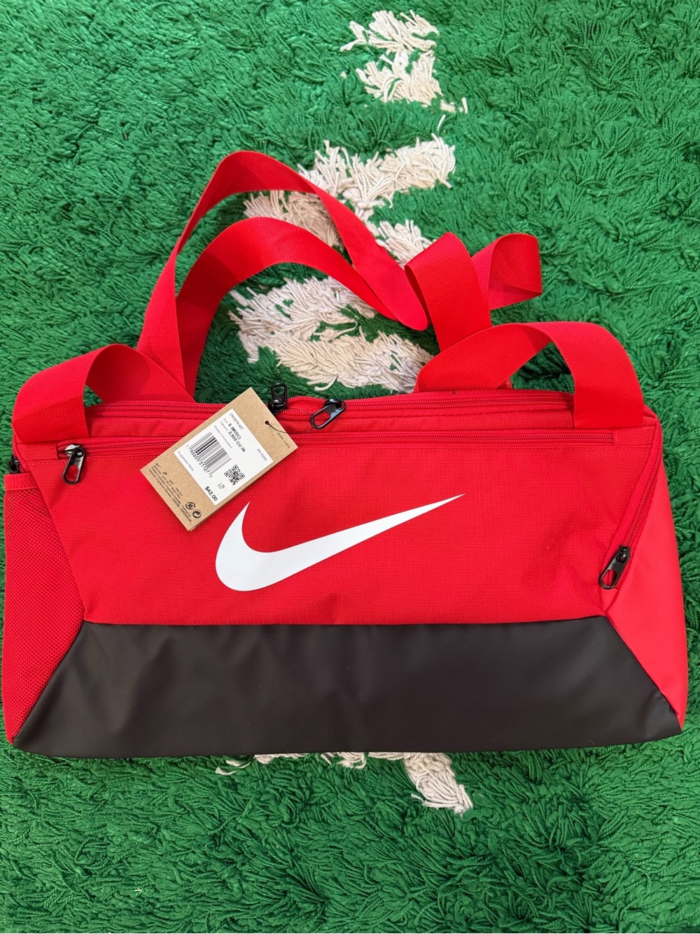 Nike Red Duffel Bag with White Swoosh and Black Base